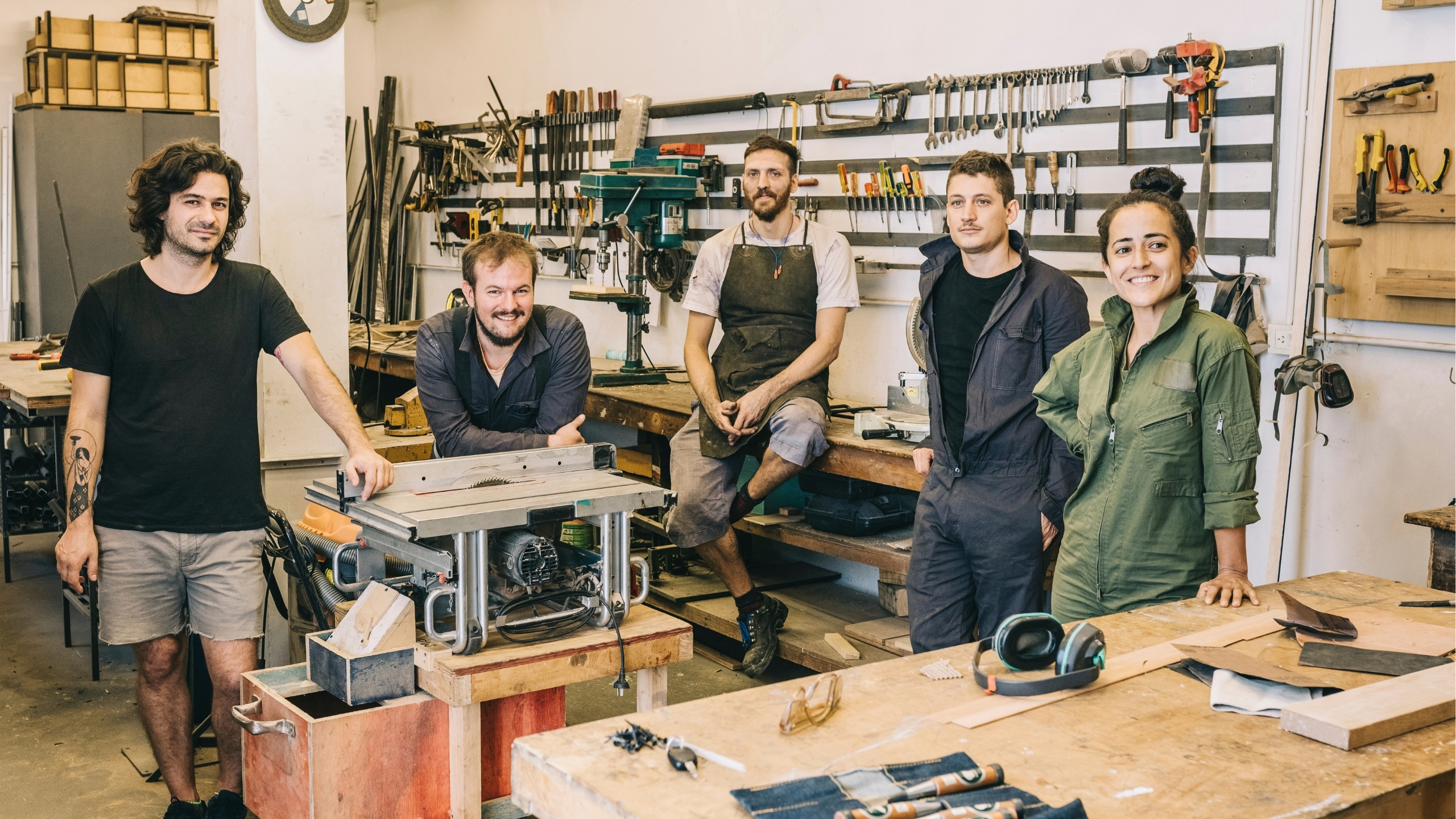 Workshop team posing among their workbenches